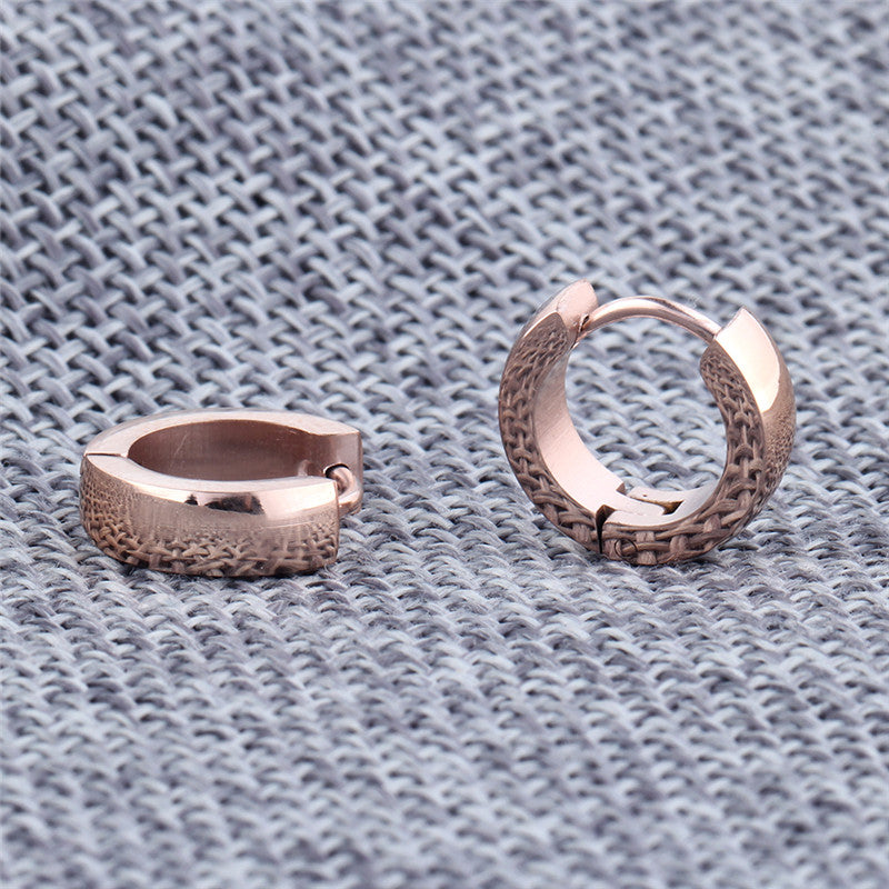 Stylish rose gold stainless steel stud earrings with a textured design, perfect for unisex fashion and versatile outfits.