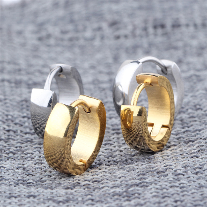 Stylish stainless steel stud earrings in silver and gold, perfect for a trendy unisex look.