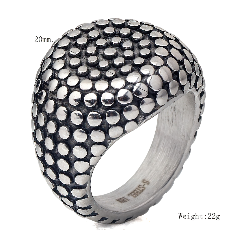 Close-up of a vintage stainless steel unisex ring, featuring a unique dotted texture and modern design.