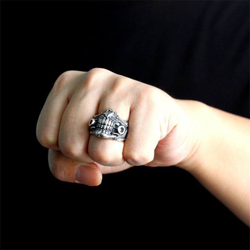 Close-up of a hand wearing a punk rock skull mask ring, perfect for cosplay and alternative fashion.
