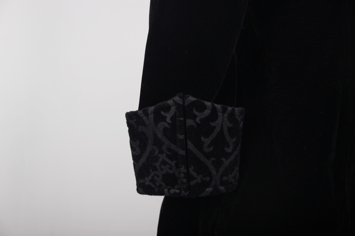 Close-up of steampunk black male velvet coat sleeve showcasing intricate gothic fabric design.
