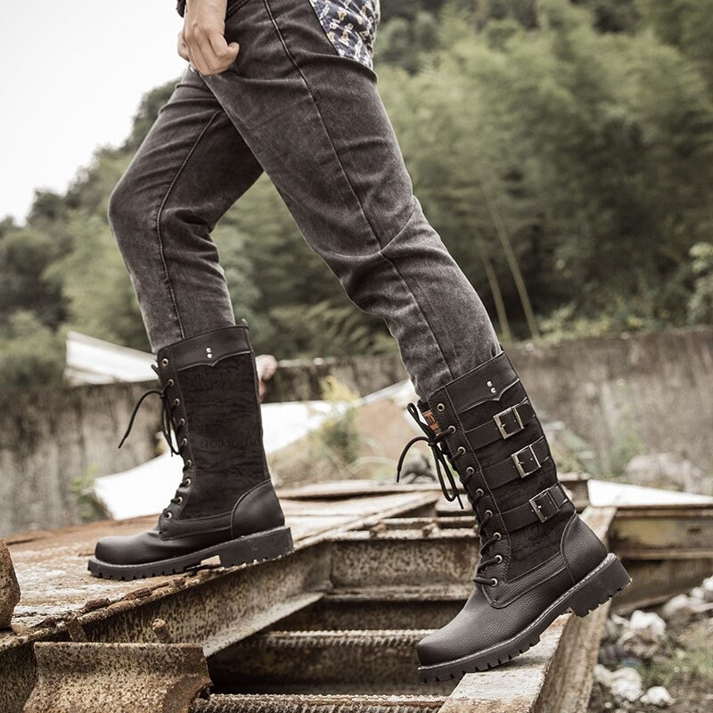 Person wearing stylish mid-calf combat boots with lacing and buckles, perfect for steampunk and alternative fashion.