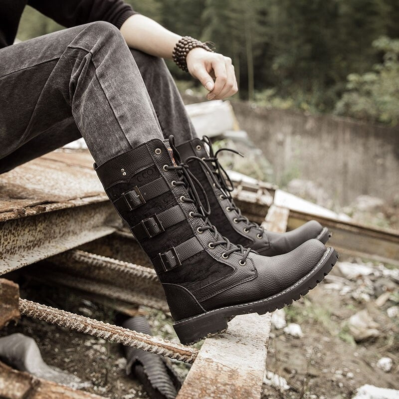 Steampunk mid-calf military combat boots with lacing, stylishly worn in a rugged outdoor setting.