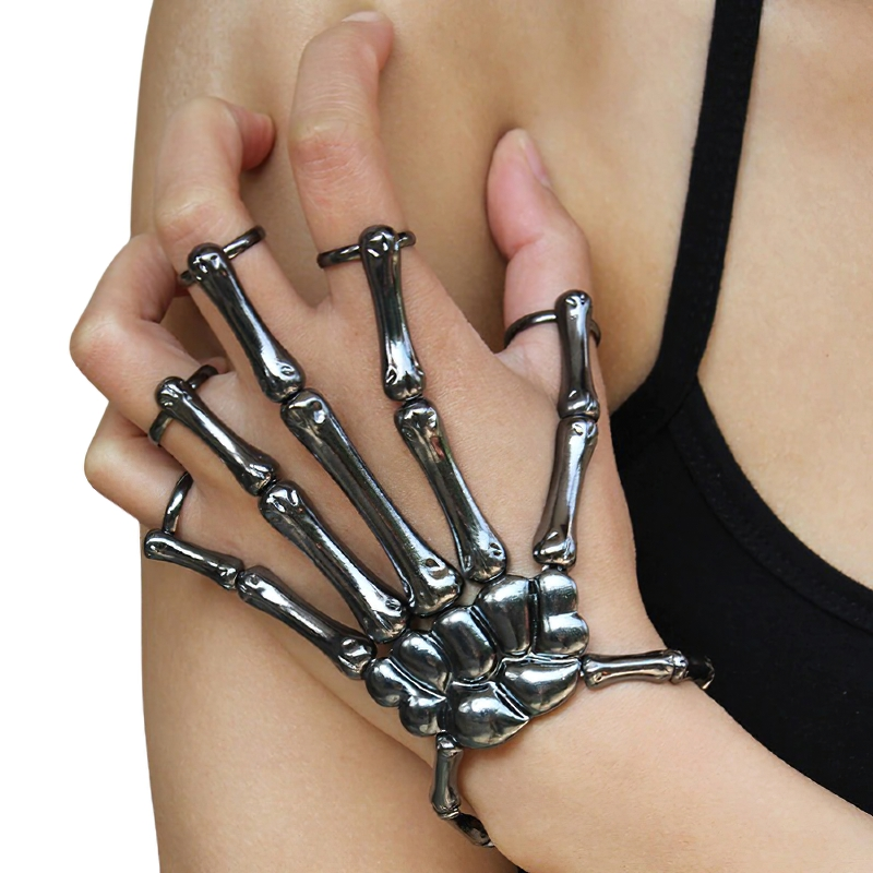 Close-up of a gothic skeleton hand bracelet on a person's arm, showcasing its striking unisex design.