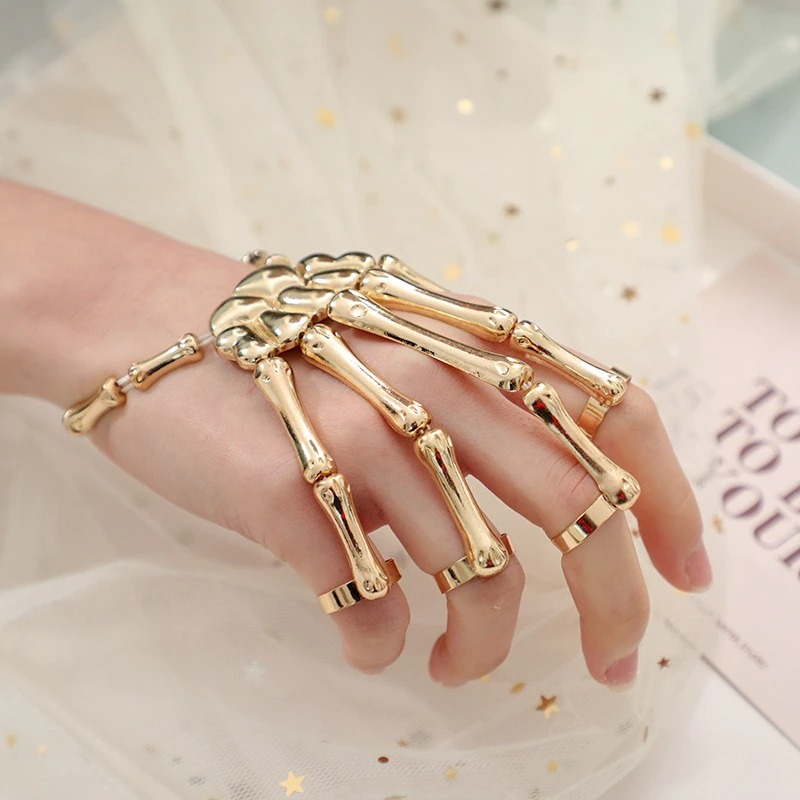 Gothic skeleton bracelet on a hand, showcasing a unisex design for men and women in a stylish gold finish.