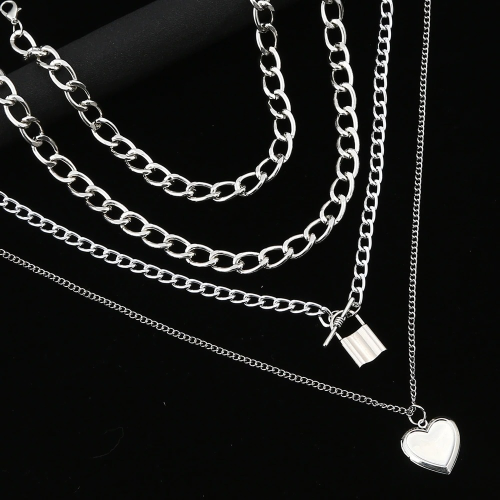 Steampunk fashion chain necklace featuring layered aluminium pendants: heart and lock charm.