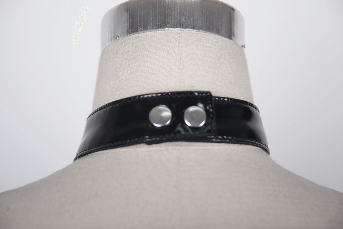 Black patent leather choker collar with silver snap buttons on a mannequin, perfect for gothic or punk rock style.
