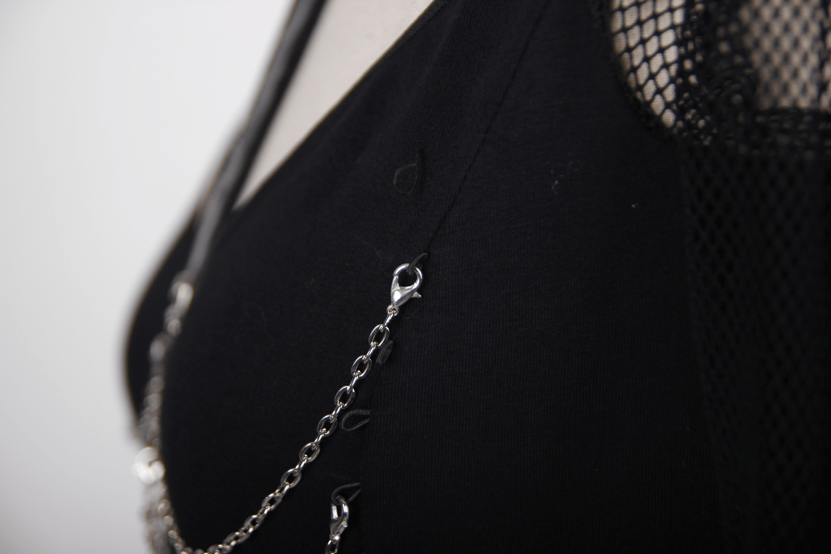 Close-up of a black cotton top featuring mesh sleeves and silver chains for a steampunk gothic look.