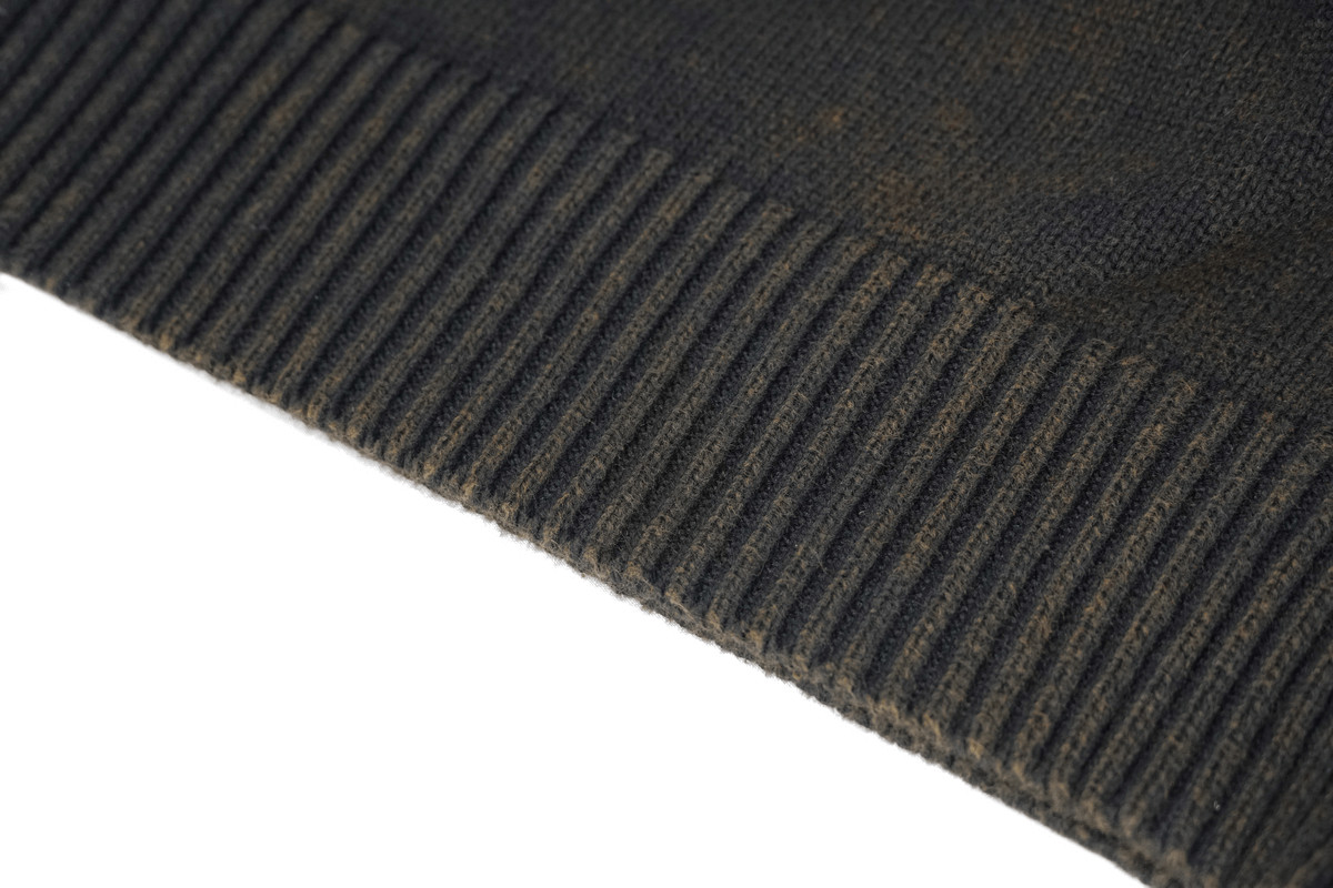 Close-up of the ribbed hem of a steampunk men's black hoodie showing texture and quality.