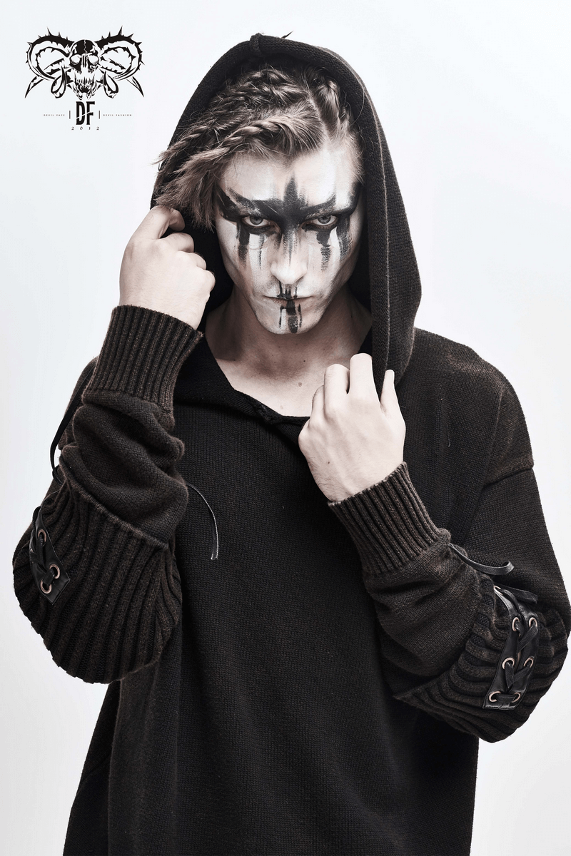 Model wearing a steampunk black loose hoodie with lace-up sleeves and striking face paint.
