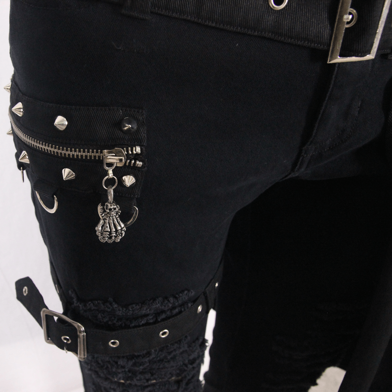 Close-up of gothic men's black steampunk pants featuring unique ripped design and zip decor with studs.