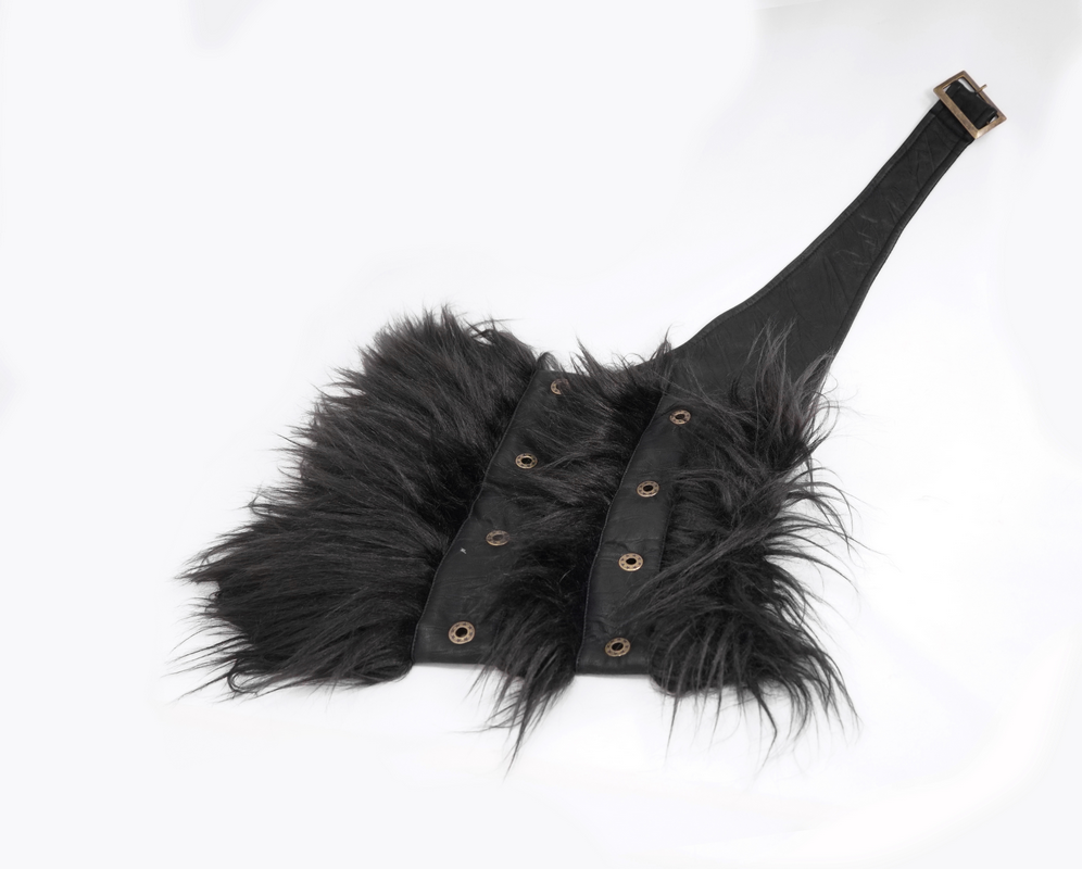Black faux fur shoulder piece with leather straps for steampunk outfits, adding vintage flair to winter fashion.