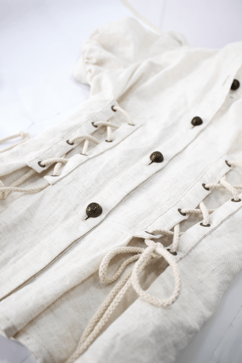 Steampunk women's white blouse featuring short puff sleeves and lace-up detailing for a vintage-inspired look.