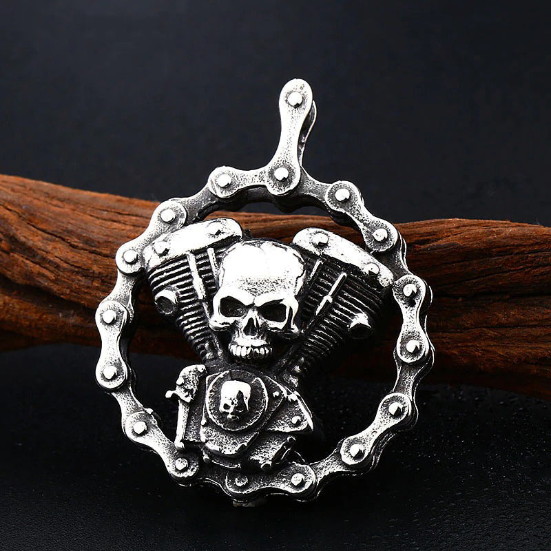 Steel skull motorcycle engine pendant necklace on wooden background, perfect for bikers and rock fashion.