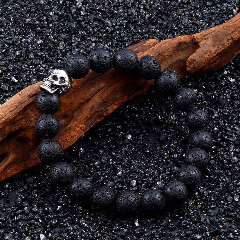 Stylish black lava stone bracelet with silver skull, perfect for alternative fashion and casual outings.