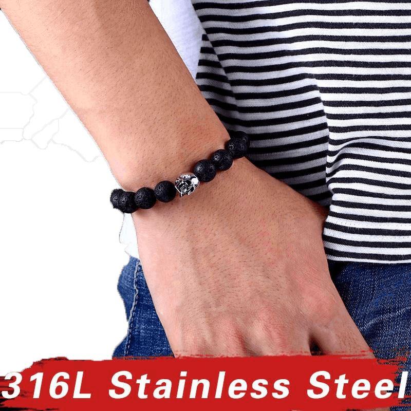 Unisex skull lava stone bracelet on wrist, made with 316L stainless steel accents and black lava stones, trendy accessories.