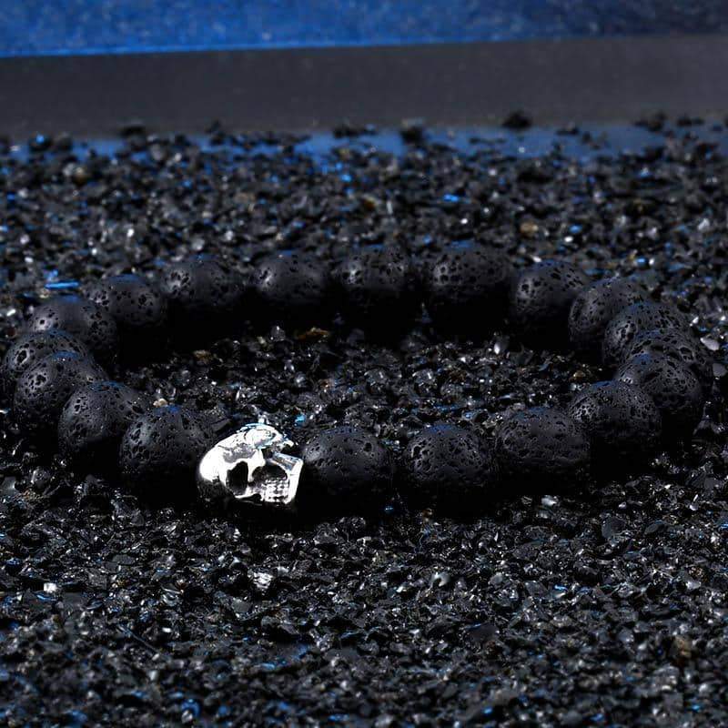 Stylish skull lava stone bracelet on black textured surface, perfect for any occasion and unisex fashion.