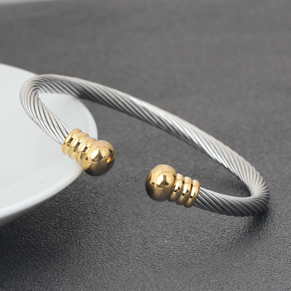 Stylish stainless steel bracelet for women with gold accents, perfect for rock-inspired outfits.
