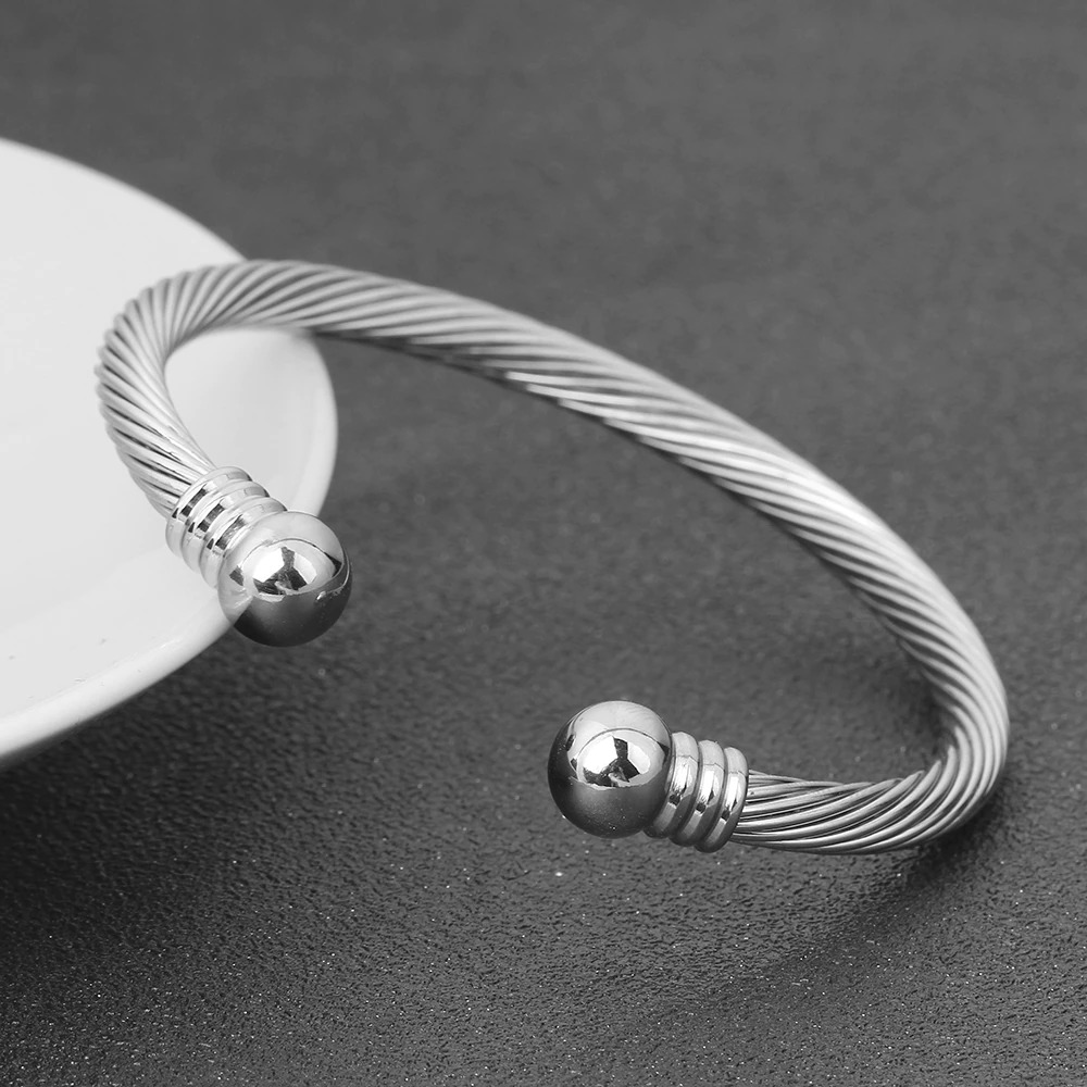 Stylish stainless steel bracelet for women, featuring a twisted design and polished ends, perfect for rock fashion.