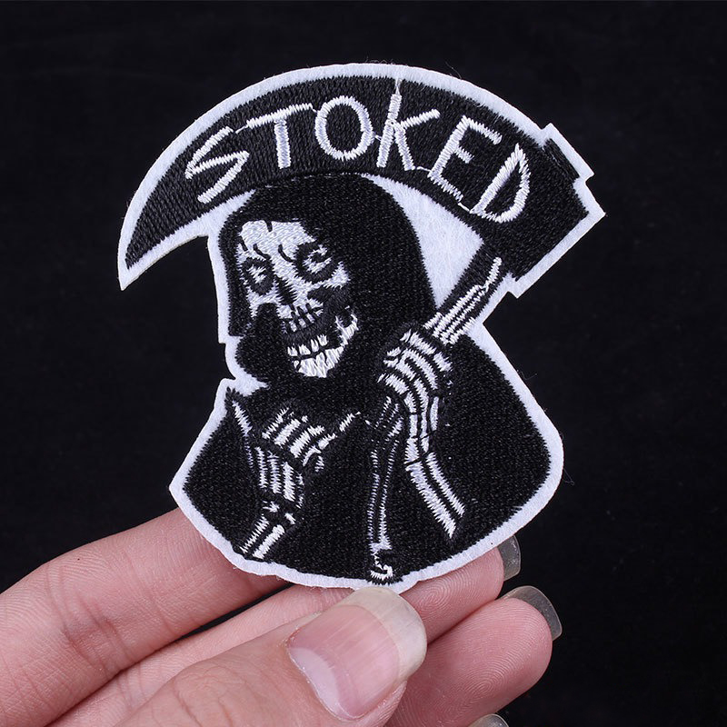 Stoked Reaper fusible patch featuring a stylish skeleton, perfect for jackets and bags in a rock style.