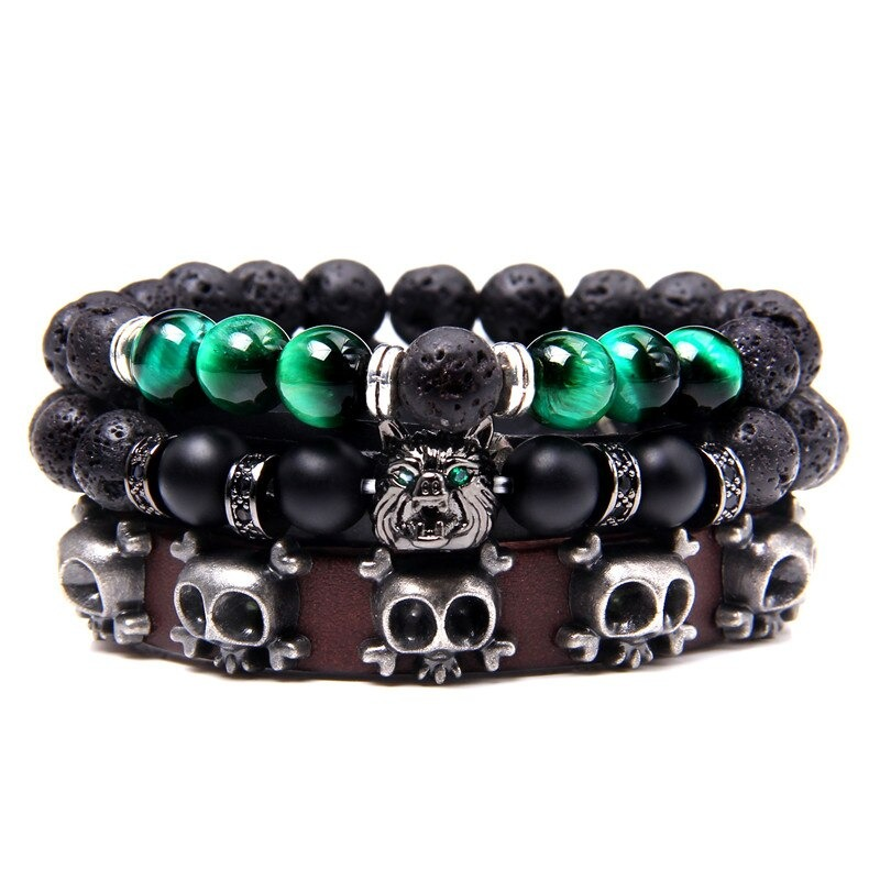 Multi-charm bracelet with natural stone beads and vintage leather featuring skull and wolf charms.