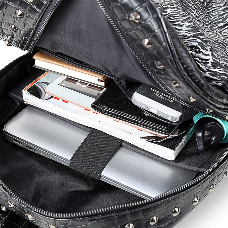 Inside view of a stylish faux leather backpack featuring organized compartments for a laptop and accessories.