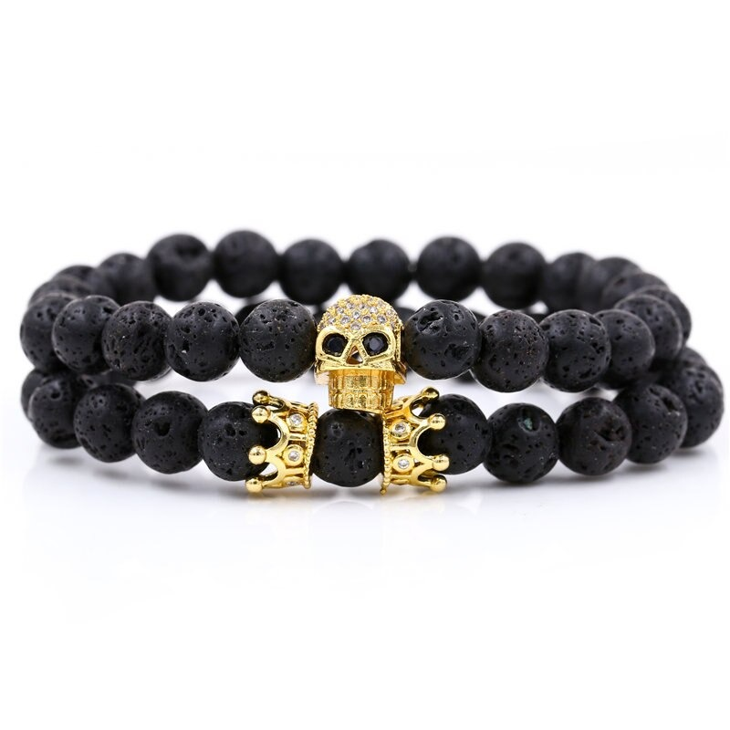 Unisex stylish bracelet featuring a skull head and crown with natural black stones in a trendy alternative design.