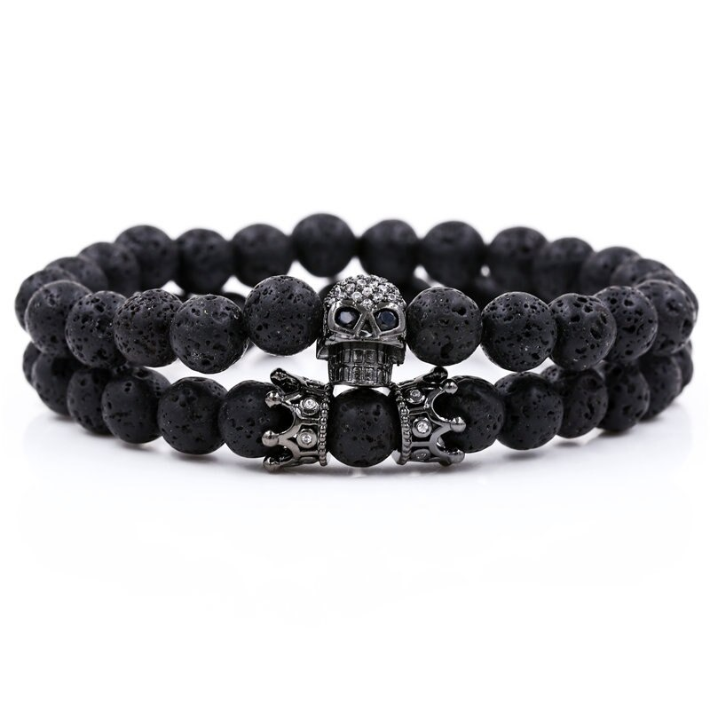Unisex stylish bracelet featuring black natural stones, skull head, and crown accents for an alternative fashion statement.