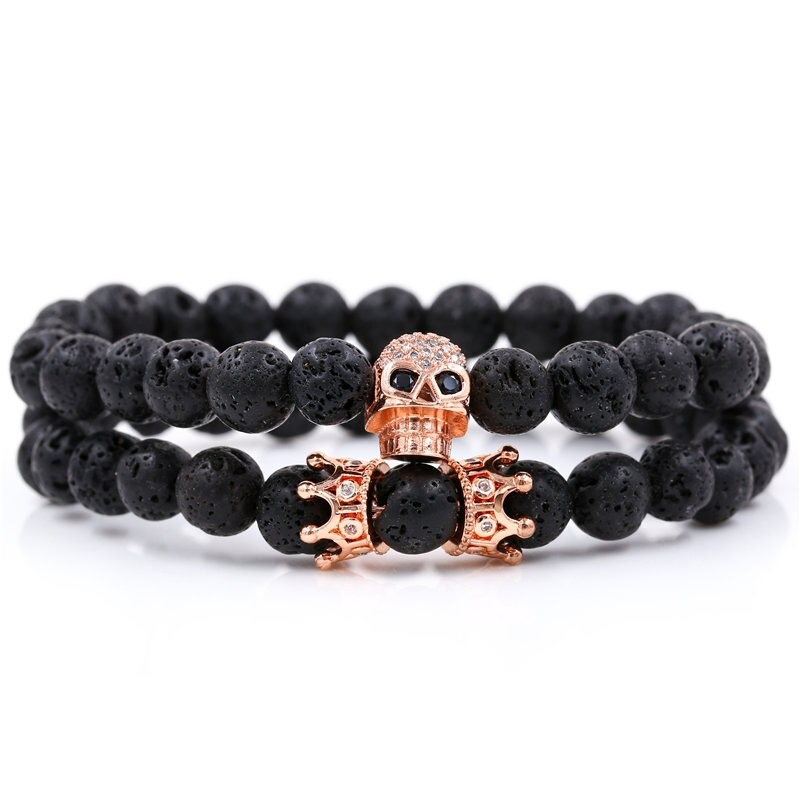 Unisex stylish bracelet featuring a skull head and crown with natural black stones in an alternative design.