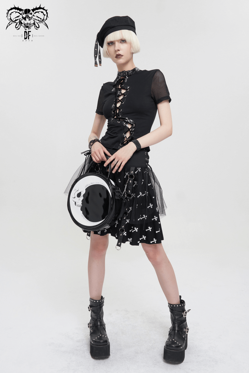 Stylish woman in gothic outfit holding a crescent moon skull handbag, perfect for a unique fashion statement.