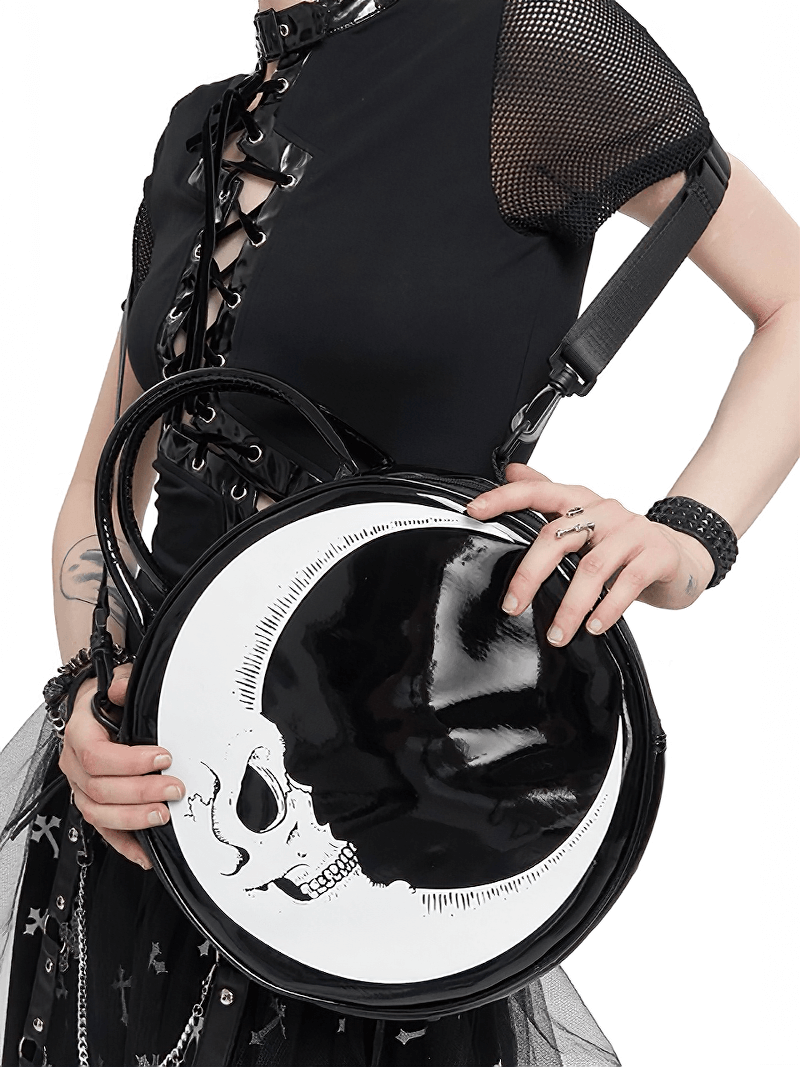 Gothic crescent moon skull handbag held by a stylish woman in black outfit, perfect for accessorizing a gothic wardrobe.