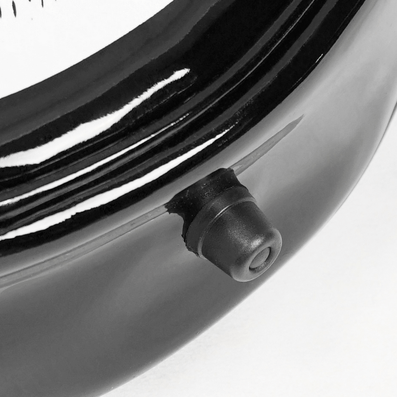 Close-up of the black crescent moon skull handbag showing the detail of the closure mechanism.