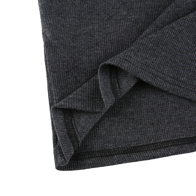 Close-up of the stylish hem of a black cropped slim top, showcasing its casual ribbed fabric and modern design.
