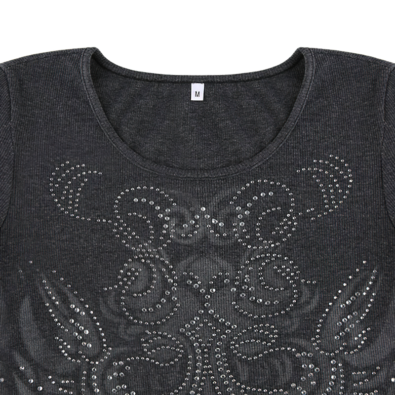 Close-up of stylish women's black cropped slim top with O-neck and rhinestone print details.