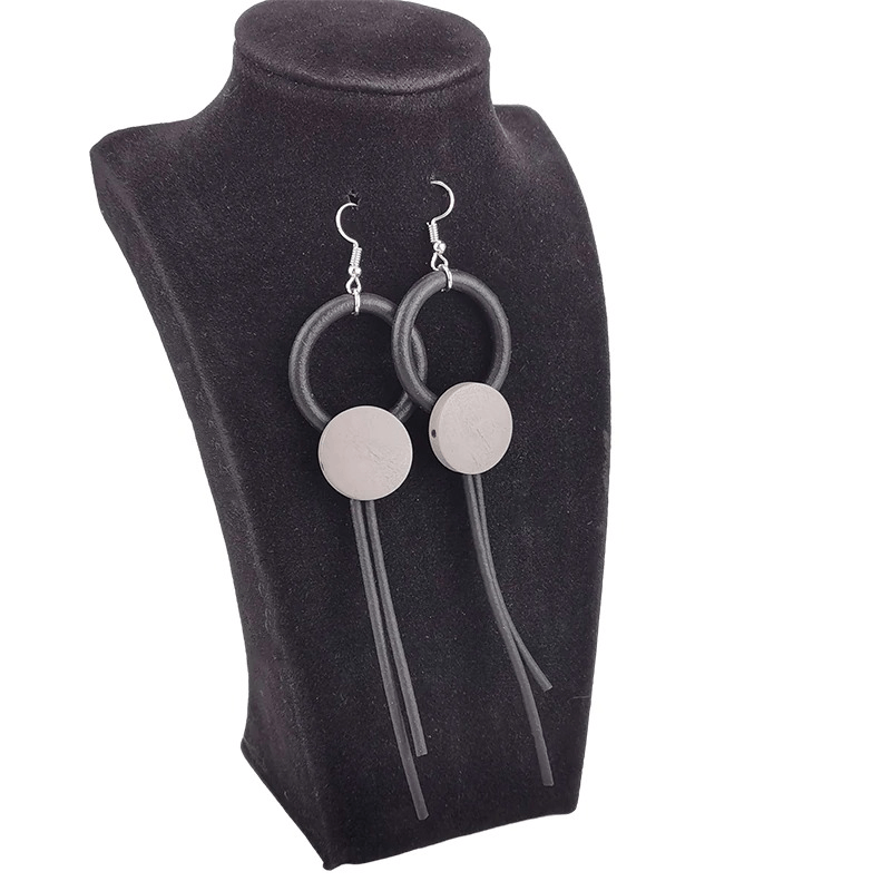 Stylish wood long earrings for women featuring a gothic design with rubber elements on a display bust.