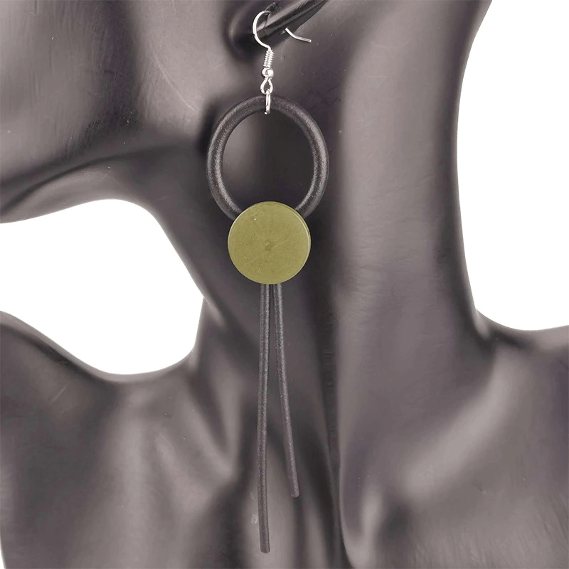 Stylish wood and rubber gothic long earrings for women, featuring a unique circular design and leather tassels.