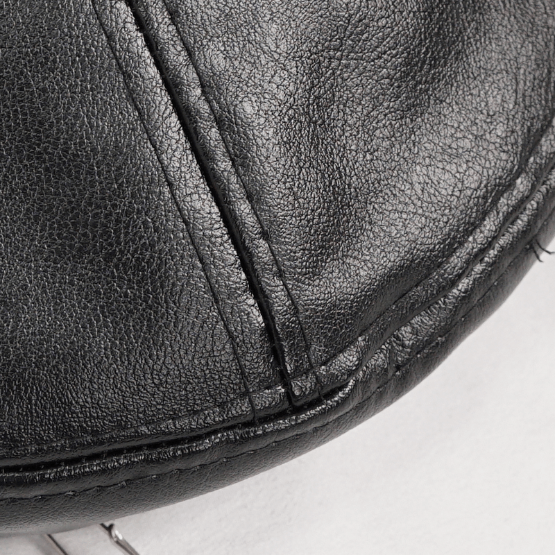 Close-up of stylish black faux leather beret showing textured surface and stitching details.