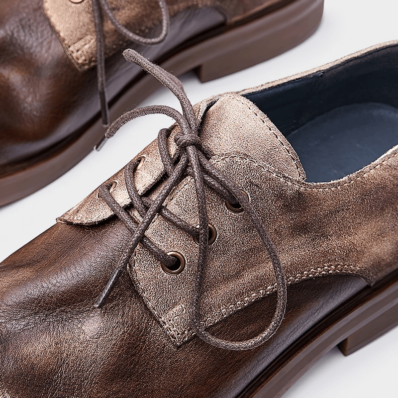 Stylish lace-up cowhide cowboy shoes for men, featuring a casual round toe design and soft leather finish.