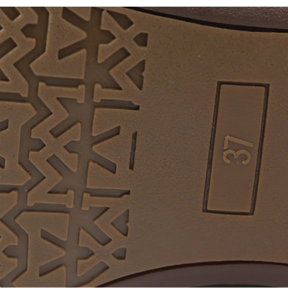 Close-up of the sole of stylish ladies genuine leather sneakers showing unique tread pattern and size 37.