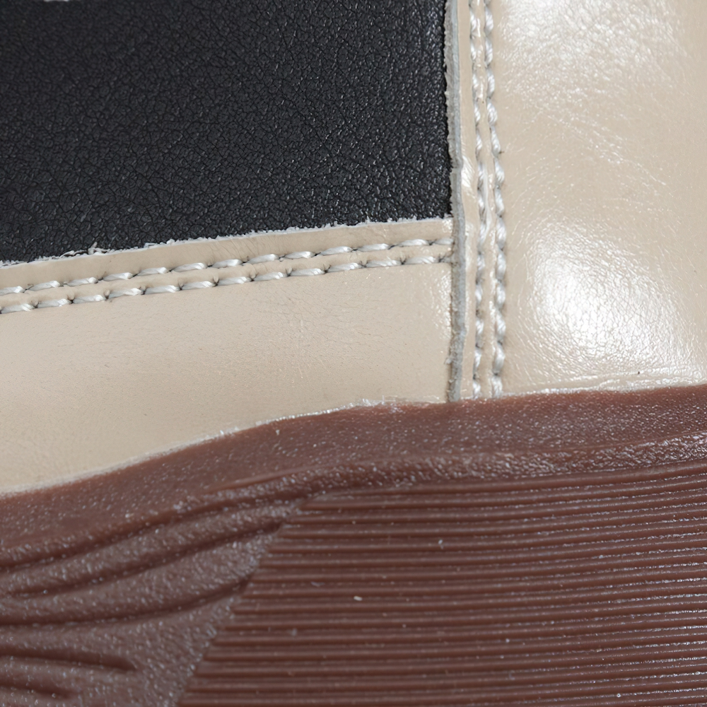 Close-up of stylish ladies genuine leather sneakers showcasing quality stitching and unique design in casual fashion.