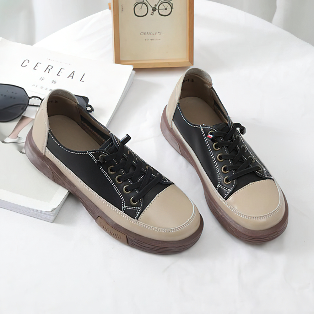 Stylish ladies genuine leather sneakers with black and beige design, perfect for casual fashion and comfortable wear.