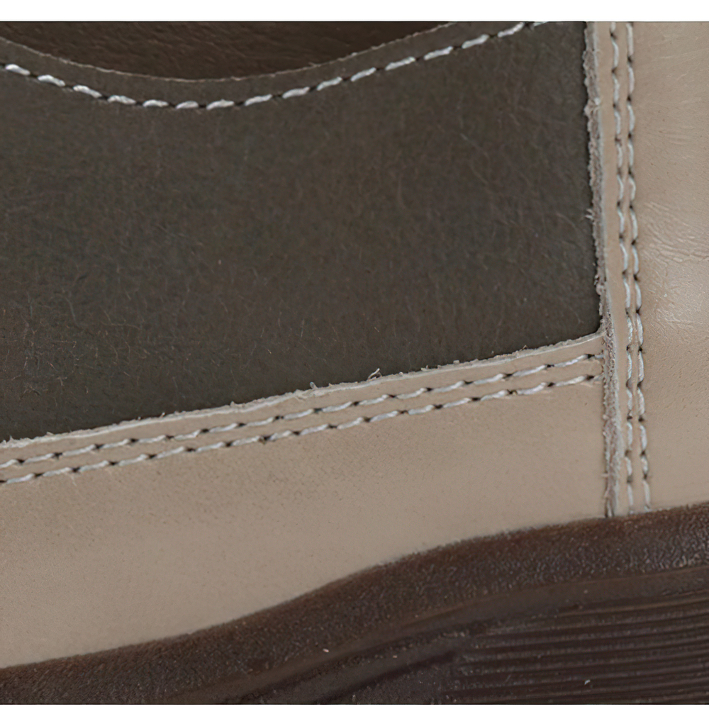 Close-up of stylish ladies genuine leather sneakers showcasing quality stitching and textured materials.