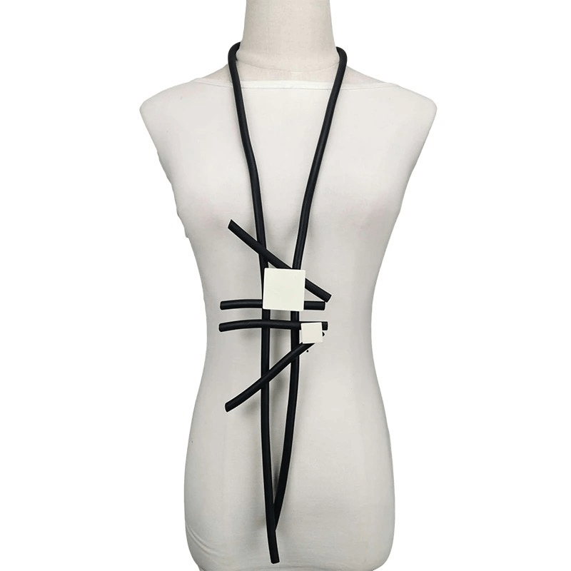 Stylish long statement necklace for women featuring a square wood pendant and rubber accents, perfect for casual outfits.