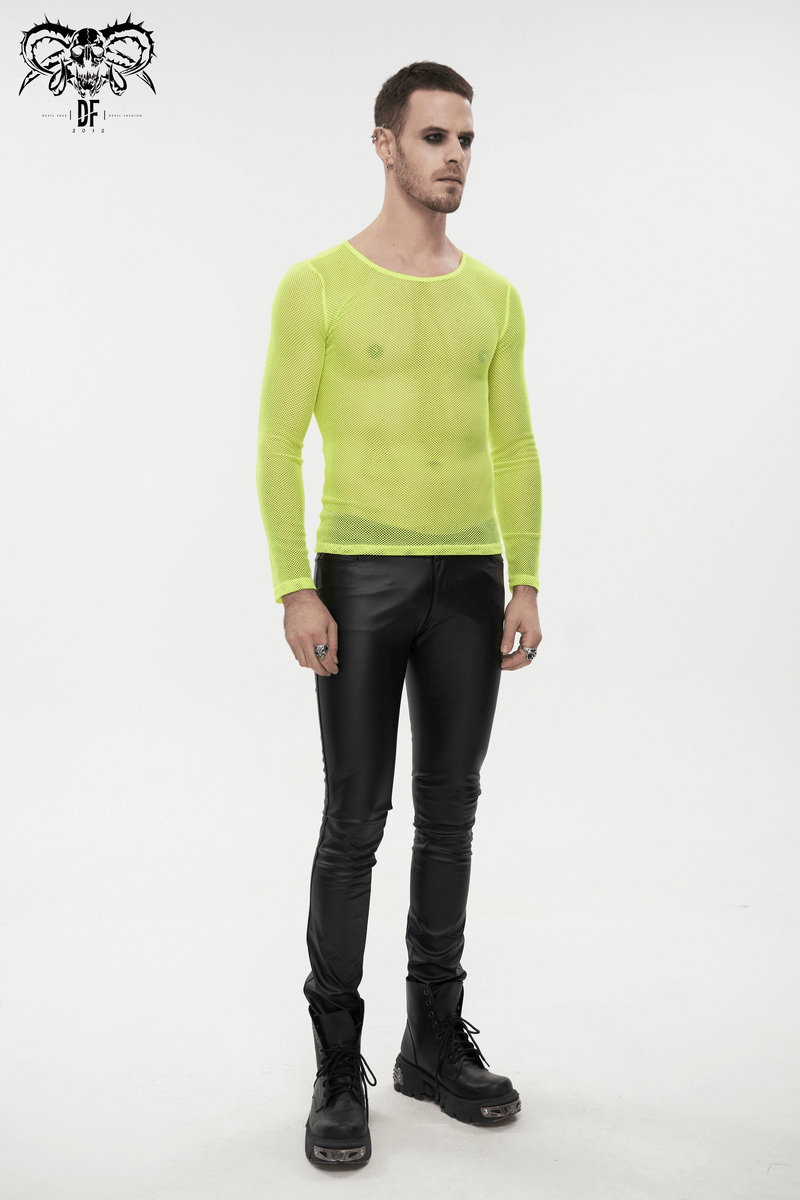 Stylish male model wearing a fluorescent yellow long sleeve mesh top paired with black pants, showcasing alternative fashion.