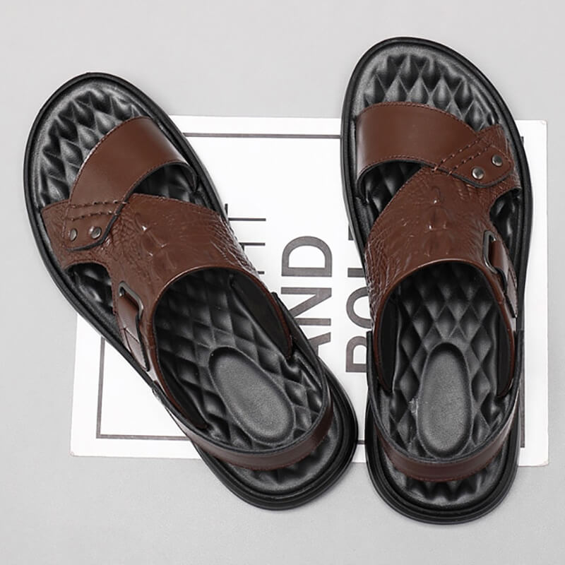 Stylish men's genuine leather sandals with strap buckle on a gray background, showcasing their comfort and design.