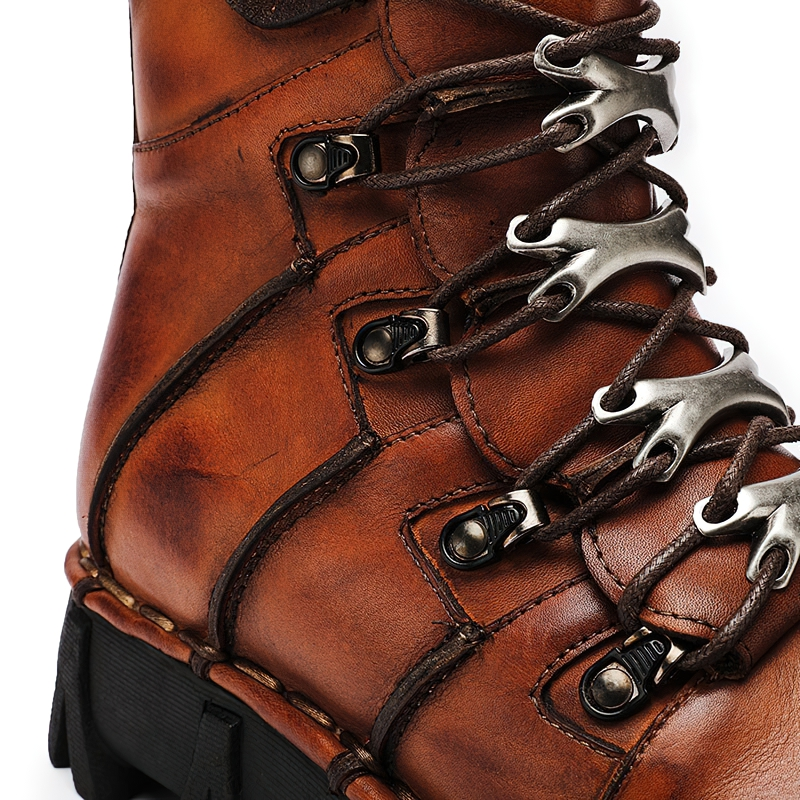 Close-up of stylish genuine leather motorcycle boots for men with metallic eyelets and sturdy laces.
