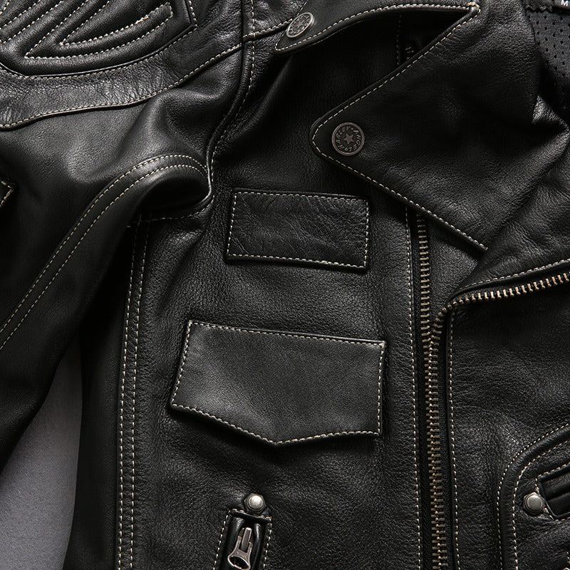 Close-up of a stylish multi-pocket black leather motorcycle jacket showcasing the collar, zippers, and pockets.