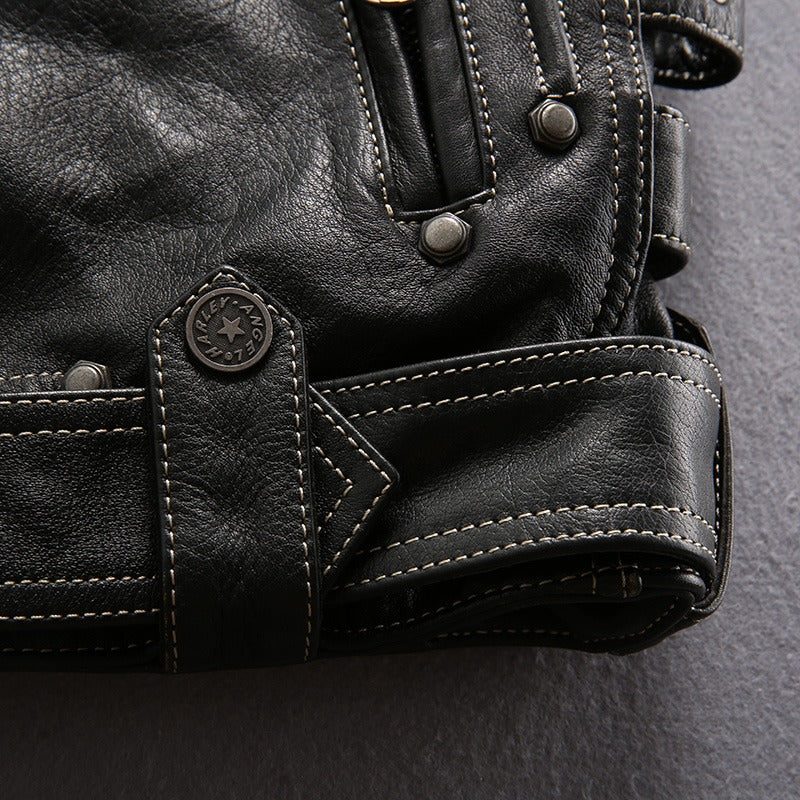 Close-up of stylish multi-pocket genuine leather motorcycle jacket showing detailed stitching and hardware.