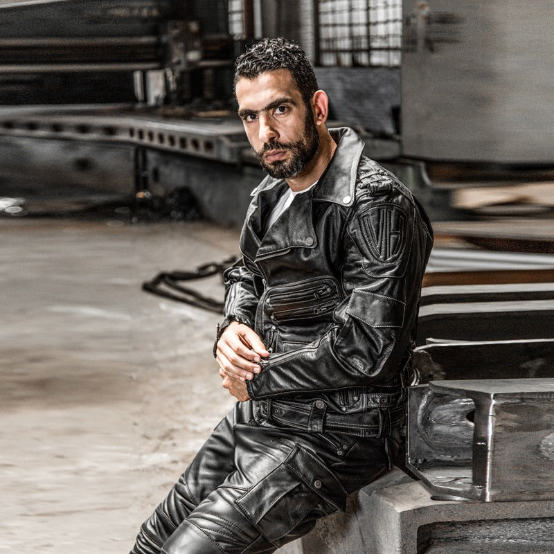 Stylish man wearing a multi-pocket genuine leather motorcycle jacket, showcasing old school biker style.