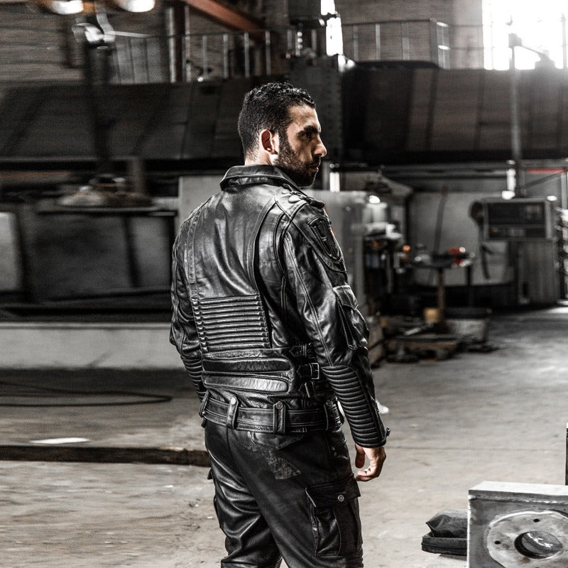 Stylish multi-pocket genuine leather motorcycle jacket for men, showcasing classic biker style in an industrial setting.